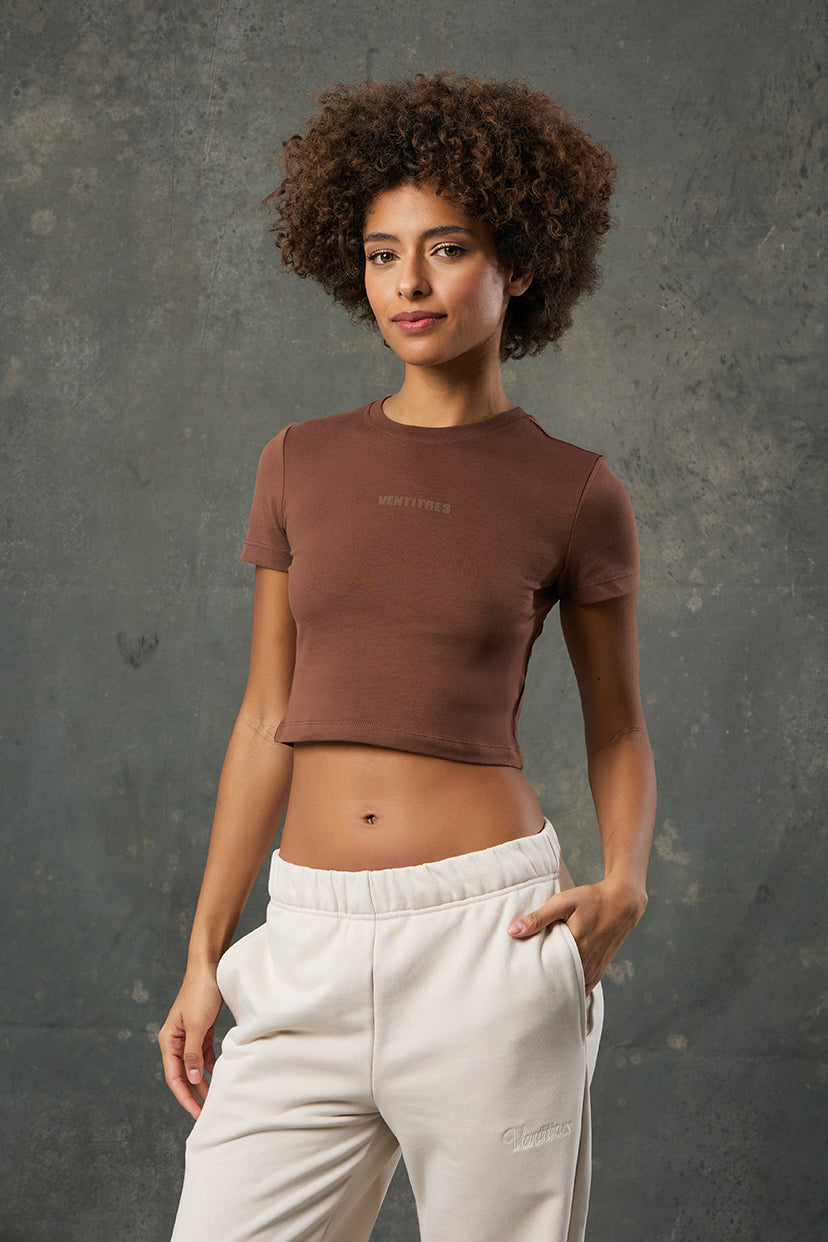 Luna Kahverengi Slim Fit Crop, vücuda oturan yapısı ve sıcak tonuyla stil sahibi bir görünüm sunar. Günlük kombinlerinize minimal ve zarif bir dokunuş katarken esnek kumaşıyla gün boyu rahatlık sağlar. Modern kesimiyle hem spor hem şehir stiline uyum gösterir.